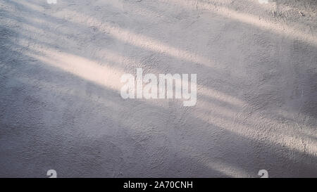 concrete polish wall in Loft style  with nature sunlight lie on wall . Abstract empty gray concrete room interior background . Sunlight on surface of Stock Photo