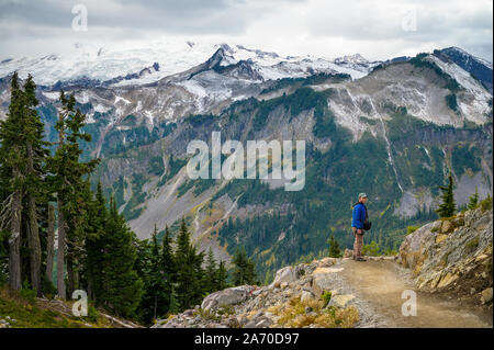 Male With Puffy Jacket with Mountain Views Stock Photo
