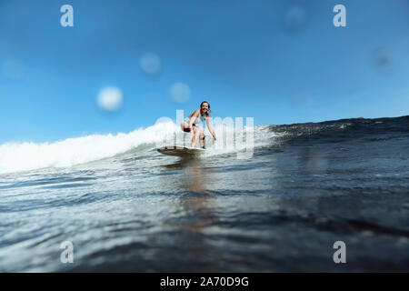 Smiling woman surfing Stock Photo
