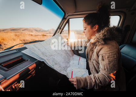 Young woman looking at a map during a Californian road trip Stock Photo