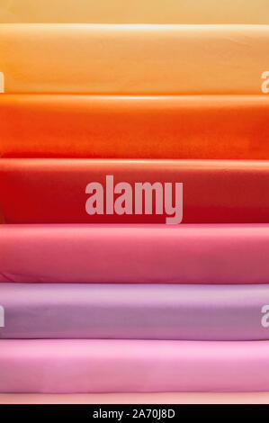 Modern packaging materials for florists. Delicate autumn colors, pearlescent tone of the material. The colored coils on the window market. Stock Photo