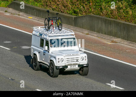 2011 white Land Rover Defender 110 XS TD D/C; UK Vehicular traffic, transport, modern vehicles, saloon cars with private number plate, personalised, cherished, dateless, DVLA registration marks, registrations, south-bound on the 3 lane M6 motorway highway. Stock Photo