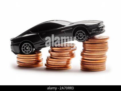 Car model over a lot of money stacked coins on white background Stock Photo