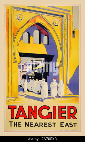 1920’s Vintage Travel Poster TANGIER the nearest east. Lithograph of Gates to Medina the old city Tangier (Tanger)  Morocco. The Medina, the top attraction of Tangier, is a labyrinth of alleyways both commercial and residential. It is contained by the walls of a 15th-century Portuguese fortress Stock Photo