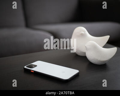 UK, October 2019: Pixel 4 white smart phone and decor in home environment on coffee table Stock Photo