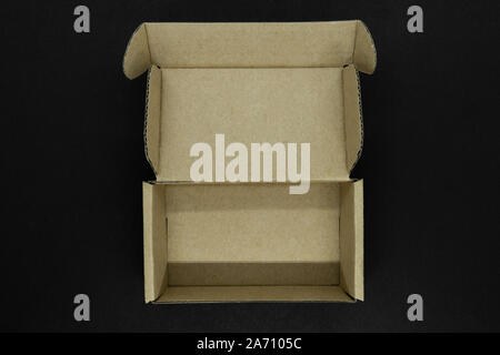Top view of opened cardboard rectangle box on matte black background Stock Photo