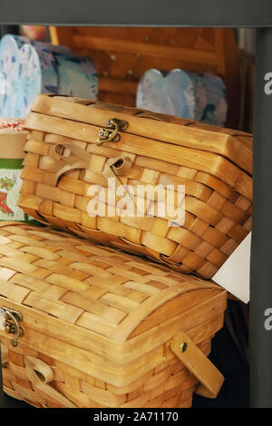 Handmade wicker colorful baskets of different sizes on the shelf of the market. Handmade crafts. Reusable packaging. No plastic bags. Stock Photo
