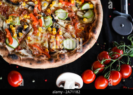 tasty italian pizza with cherry tomatoes, fresh basil & gorgonzola cheese Stock Photo