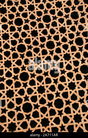 Geometric pattern made up of stars, triangles & shapes, in a gold colour against black. Stock Photo