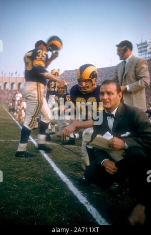 LOS ANGELES, CA - NOVEMBER 10: John Hock #63 and head coach Sid Gillman of the Los Angeles Rams kneel on sideline during an NFL game against the San Francisco 49ers on November 10, 1957 at the Los Angeles Coliseum in Los Angeles, California.  (Photo by Hy Peskin)
