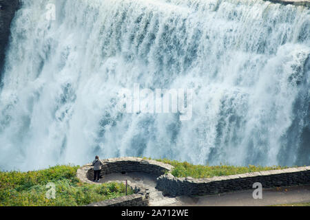 woman standing overlooking Middle Falls at Letchworth State Park in upstate New York Stock Photo