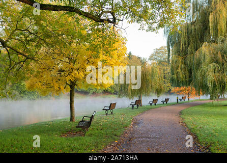 Autumn trees along a flooded river avon on an autumn morning. Stratford Upon Avon, Warwickshire, England Stock Photo