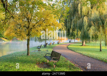 Autumn trees along a flooded river avon on an autumn morning. Stratford Upon Avon, Warwickshire, England Stock Photo