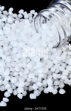 Close up picture of polypropylene (PP) granules on black background, selective focus. Stock Photo