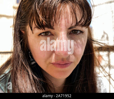 Portrait of a young brunette woman, gaze straight at the camera, closeup Stock Photo