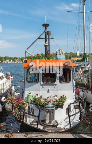 Stockholm harbor, view of a vintage boat moored on the east shore of Skeppsholmen island in Stockholm city harbour, Sweden. Stock Photo