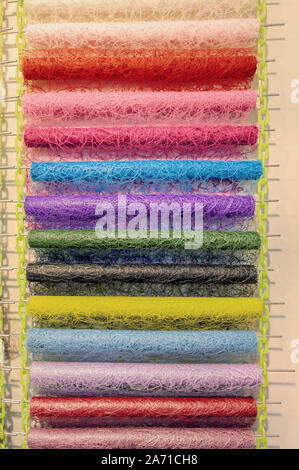 Modern packaging wicker and openwork materials for florists. Delicate pearlescent tone of the material. The colored coils on the window market. Stock Photo