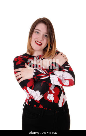 A young smiling woman standing in black tights and colorful blouse with her arms crossed, isolated for white background Stock Photo
