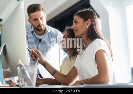 Coworkers team picture in modern office. Project managers work new idea Stock Photo