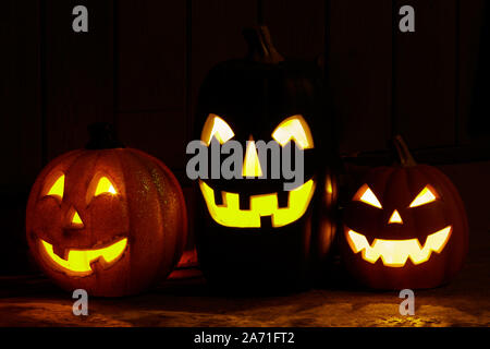 Three Jack O Lanterns Glowing in the Dark Stock Photo