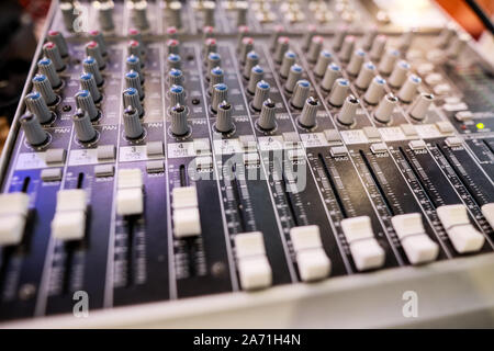 Shallow depth of field (selective focus) image with the controls on an audio mixer Stock Photo