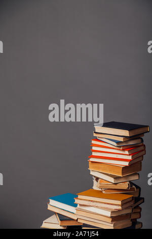 a lot of different educational books on a gray background Stock Photo