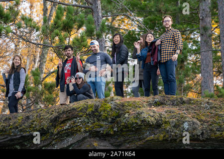 October 19, 2019 - Bayfield, Wisconsin: A group of happy hikers explore the trails in the Apsotle Islands National Lakeshore from Meyers Beach during Stock Photo