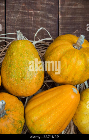Close-up photo with mini pumpkins on rustic wooden background, overhead view with copy space. Autumn concept background. Stock Photo