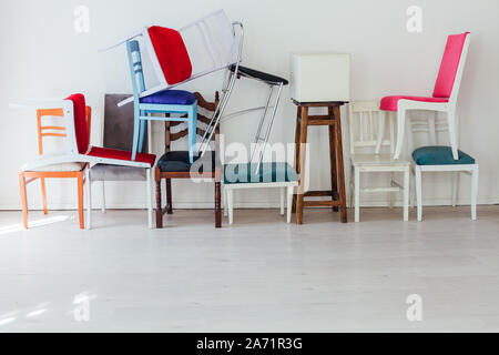 different multicolored chairs in the interior of the white room Stock Photo