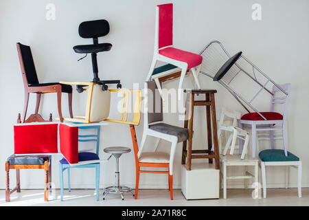 different multicolored chairs in the interior of the white room Stock Photo