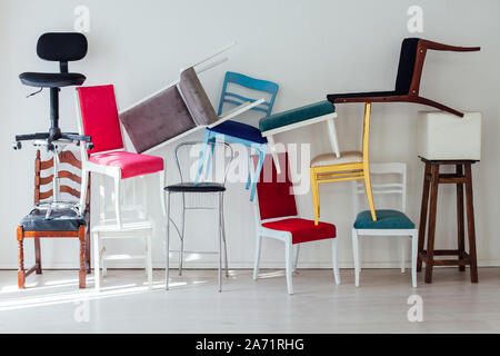 different multicolored chairs in the interior of the white room Stock Photo