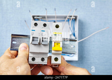 The automatic fuse Installing. In the event of overload or a short-circuit, miniature circuit breakers or  MCB safely cut the connected circuits and Stock Photo