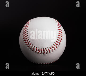 One new white baseball ball with red thread isolated on black background Stock Photo