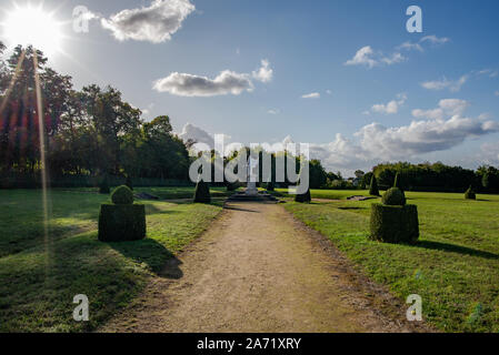 Champs-sur-Marne, France - October 6, 2019: View on an Apollo statue sets in a classical french formal garden, taken at the end of a fall afternoon wi Stock Photo