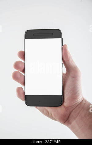 Hand holding mobile smart phone with blank screen. Isolated on white. Stock Photo