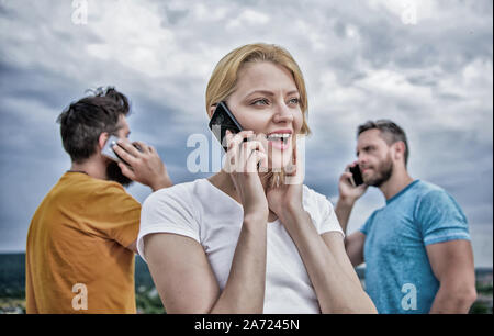 The easiest way to communicate. Mobile phone users. Group of friends talking on cell phones. Modern people with smartphones outdoor. People and technology. Using mobile communication technology. Stock Photo