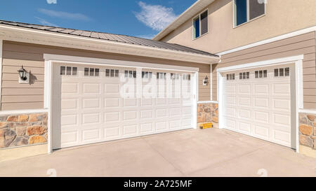 Panorama frame Drive way and garage of modern two storey home Stock Photo