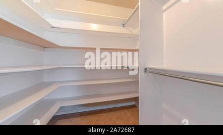 Image of a walk in closet with white walls Stock Photo - Alamy