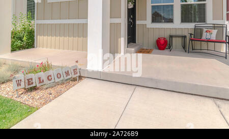 Panorama Front veranda of modern home with welcome sign Stock Photo