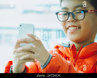 Hand kid person using smartphone or cellphone take a photo the airplan in airport. Airport most popular place for traveler or tourist and walking on w Stock Photo