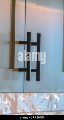Vertical frame Close up of modern kitchen cupboards and handles Stock Photo