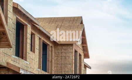 Panorama Close up of the exterior of townhomes under construction against cloudy sky Stock Photo