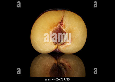 One half of fresh red plum isolated on black glass Stock Photo