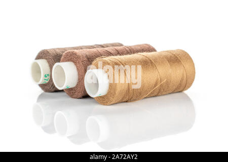 Group of three whole haberdashery item three thread spools in row isolated on white background Stock Photo