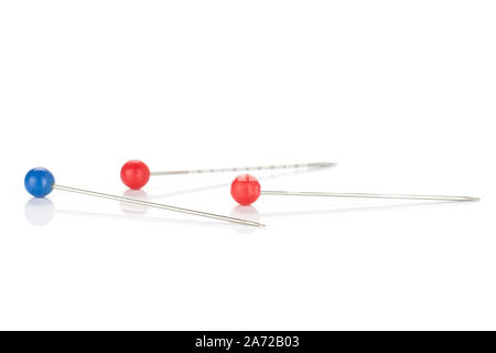 Group of three whole haberdashery item blue red needle isolated on white background Stock Photo
