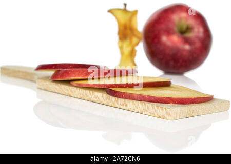 Group of one whole four slices one piece of fresh apple red delicious on wooden cutting board isolated on white background Stock Photo