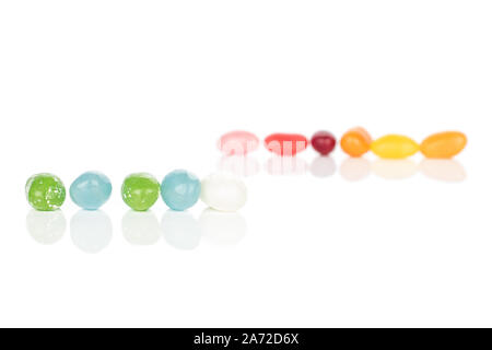 Lot of whole jelly bean candy in two lines isolated on white background Stock Photo