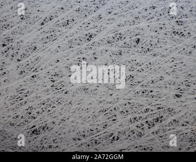 Natural dark stone, with artificially applied strips imitating cobwebs. Background, texture. Stock Photo