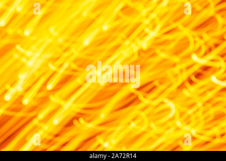 Futuristic blurred lights holiday monochrome background in yellow. Horizontal, soft focus Stock Photo