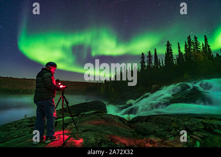 Photographer Stephen Bedingfield is shooting the Northern Lights at the Ramparts waterfalls on the Cameron River, September 8, 2019.  This is a single Stock Photo